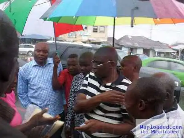 Photos: Gov Ayodele Fayose shares rice to his people under heavy rain